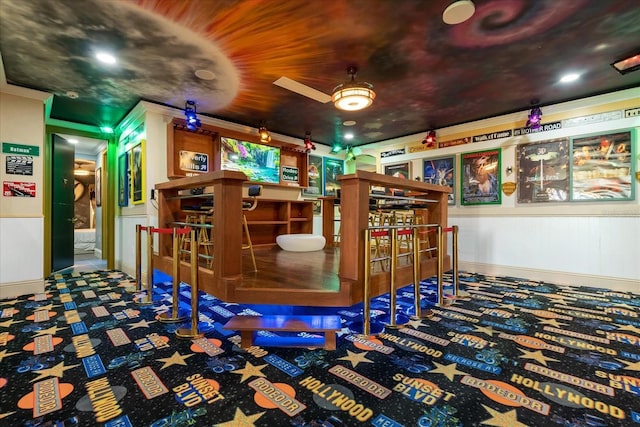 1021 Fantasy Dr, Davenport, FL 33896 - recreation room with a bar, a ceiling fan, and wainscoting
