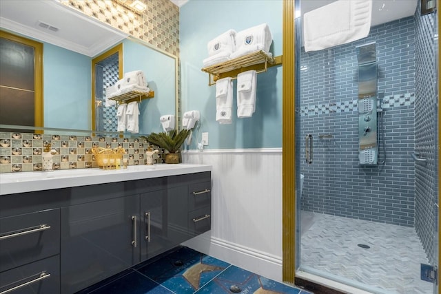1021 Fantasy Dr, Davenport, FL 33896 - bathroom featuring double vanity, a stall shower, ornamental molding, wainscoting, and tile patterned flooring