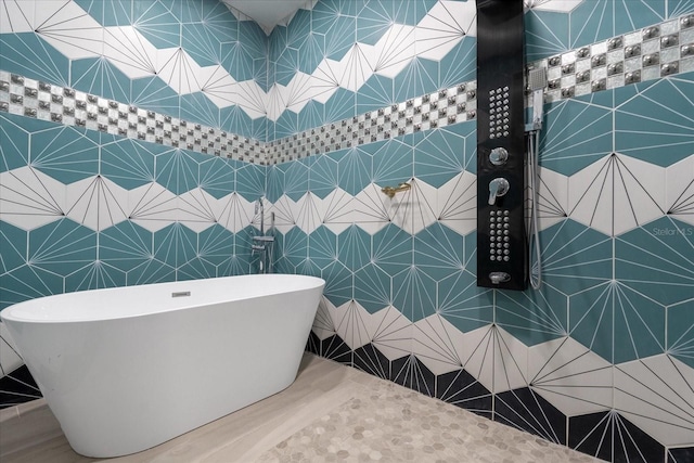 1021 Fantasy Dr, Davenport, FL 33896 - bathroom with a soaking tub and wood finished floors