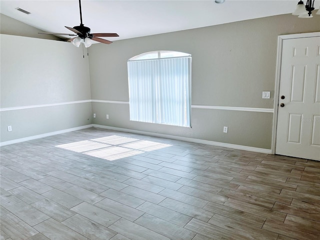 empty room with ceiling fan and light hardwood / wood-style floors