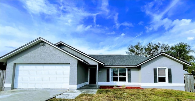 ranch-style home with a garage and a front yard