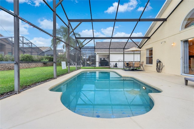 view of pool with a yard, a patio, and glass enclosure