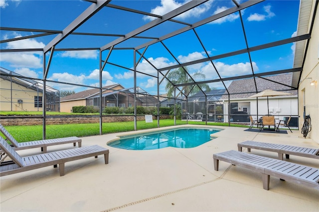 view of pool with a lanai, a patio area, and a lawn