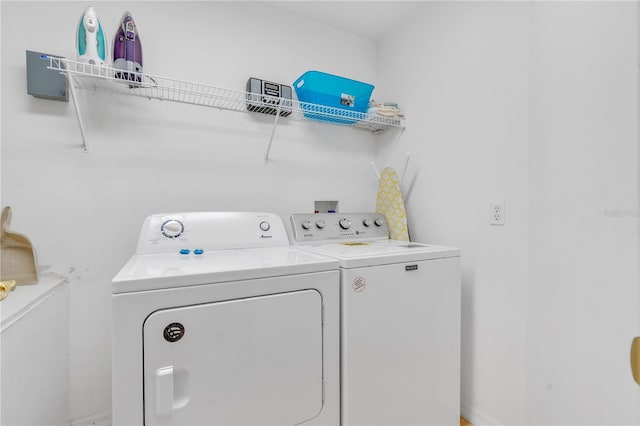 clothes washing area featuring separate washer and dryer