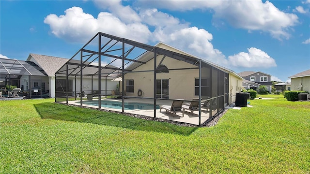 view of swimming pool with a patio area, a lanai, a yard, and central air condition unit