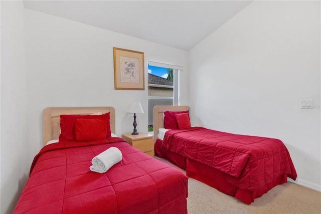 bedroom with carpet and vaulted ceiling