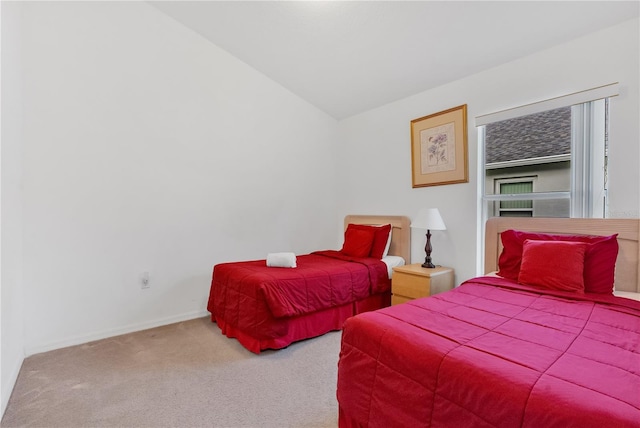 bedroom featuring carpet flooring and lofted ceiling