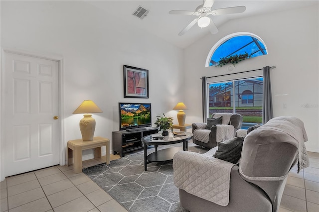 tiled living room with high vaulted ceiling and ceiling fan