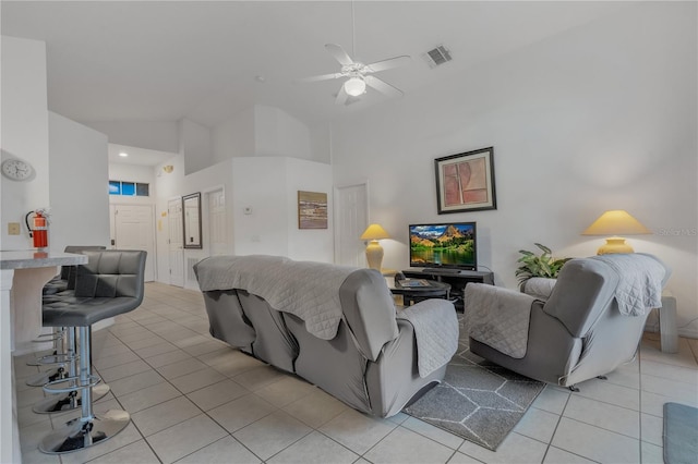 living room featuring ceiling fan, light tile patterned floors, and high vaulted ceiling