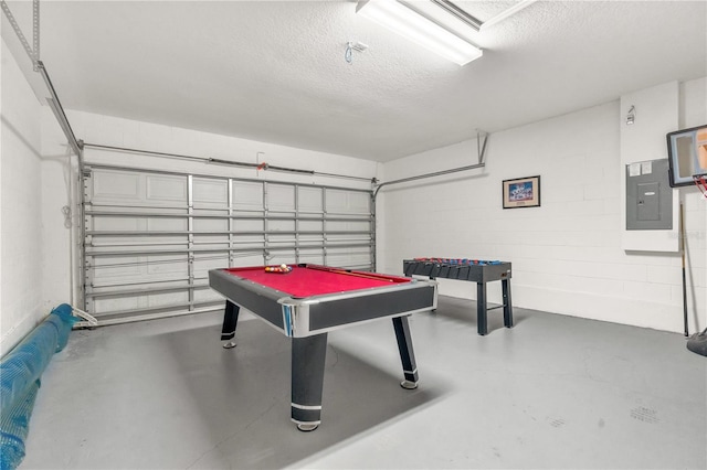 rec room with electric panel, concrete flooring, a textured ceiling, and billiards