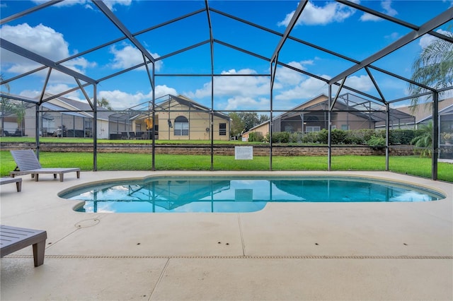 view of swimming pool featuring a lawn, glass enclosure, and a patio area