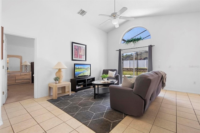 tiled living room featuring visible vents, a ceiling fan, baseboards, and high vaulted ceiling