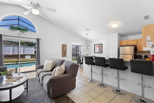 living room featuring high vaulted ceiling, ceiling fan, light tile patterned flooring, and visible vents