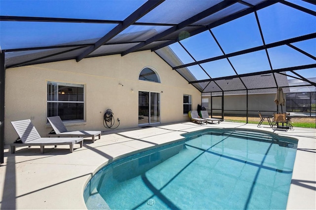 pool with glass enclosure and a patio area