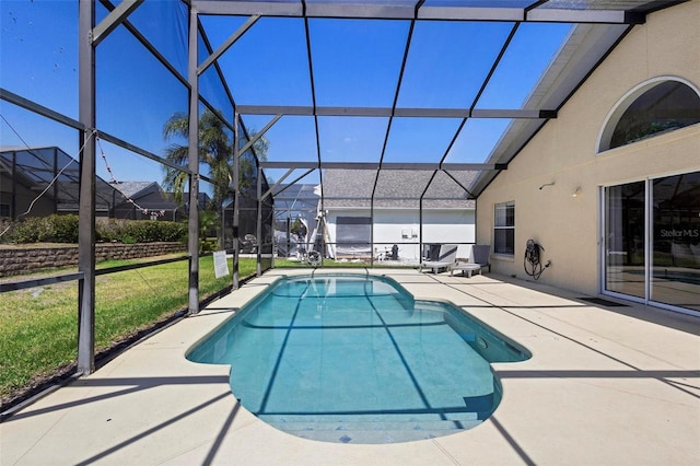 outdoor pool featuring a patio, glass enclosure, and a lawn