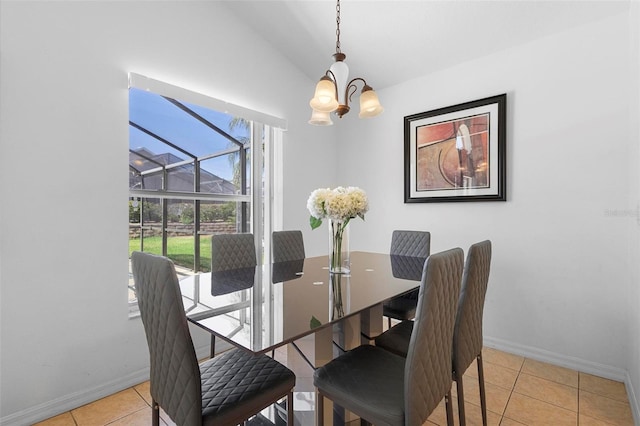tiled dining room featuring baseboards, a notable chandelier, and lofted ceiling