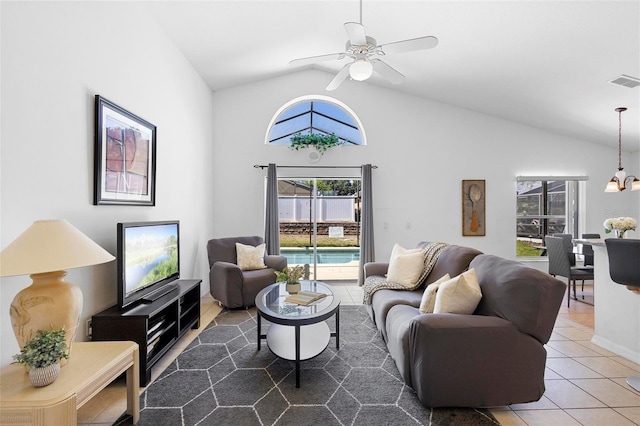 living room featuring tile patterned flooring, visible vents, ceiling fan with notable chandelier, and lofted ceiling