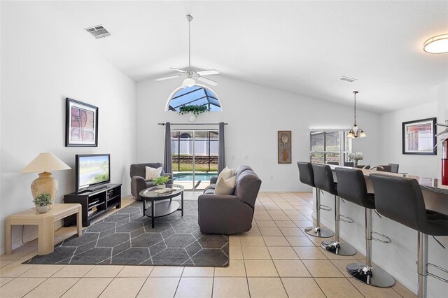 503 Balmoral Dr, Davenport, FL 33896 - tiled living area with lofted ceiling, ceiling fan, healthy amount of natural light, and baseboards