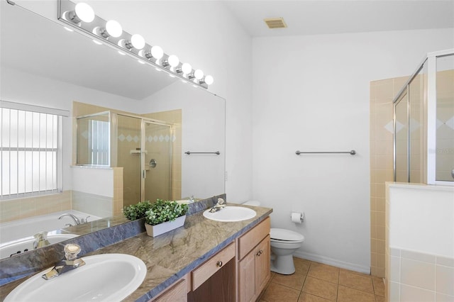 503 Balmoral Dr, Davenport, FL 33896 - bathroom with a shower stall, double vanity, tile patterned floors, toilet, and a garden tub