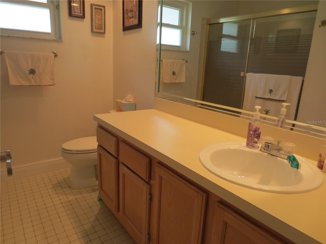 bathroom with tile patterned flooring, vanity, toilet, and a shower with door