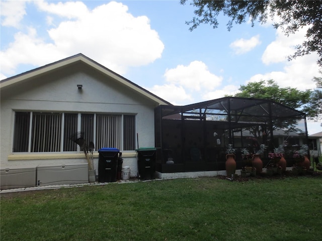 view of property exterior with a lawn and a lanai