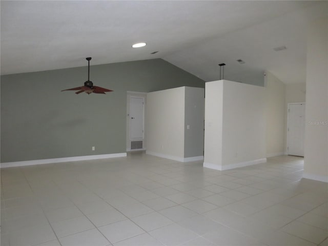 tiled spare room with ceiling fan and vaulted ceiling