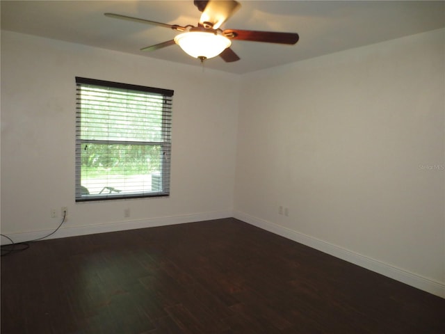 spare room featuring ceiling fan and dark wood-type flooring