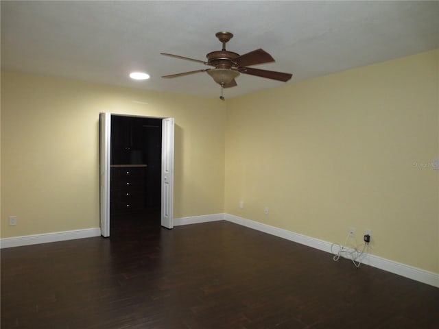 empty room with dark hardwood / wood-style flooring and ceiling fan