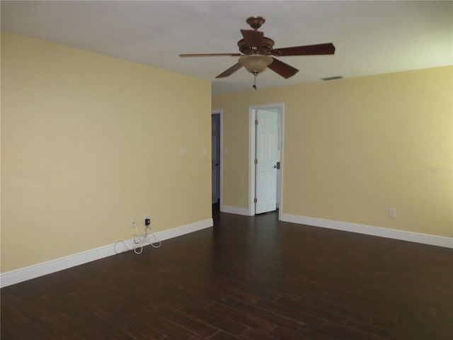 empty room with ceiling fan and dark hardwood / wood-style floors