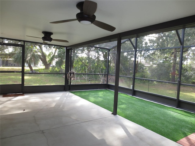 unfurnished sunroom featuring ceiling fan