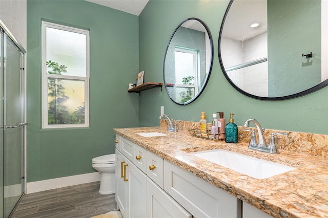 bathroom with toilet, vanity, hardwood / wood-style floors, and walk in shower