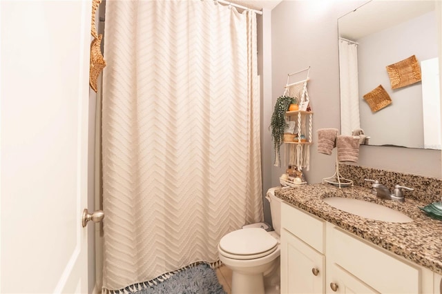 bathroom with vanity, toilet, and tile patterned floors