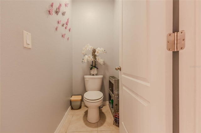 bathroom featuring toilet and tile patterned flooring