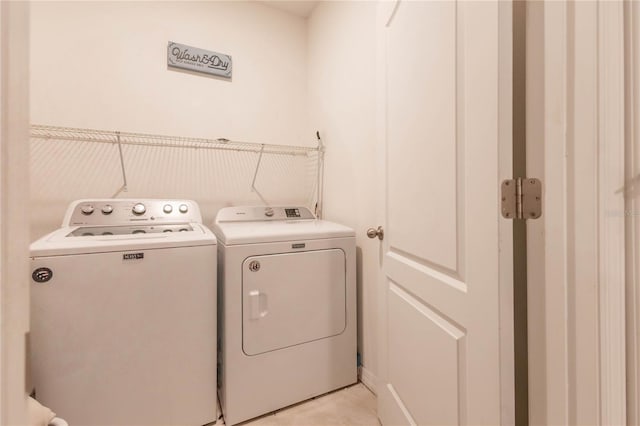 laundry area with washing machine and clothes dryer