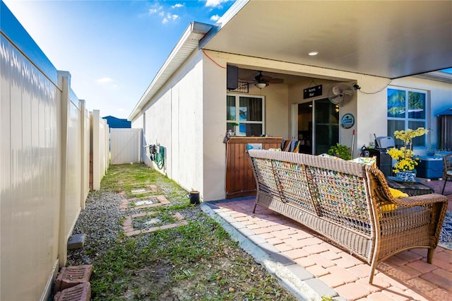 back of property with a patio and ceiling fan