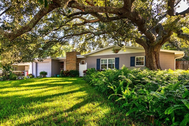 single story home with a front lawn and a garage