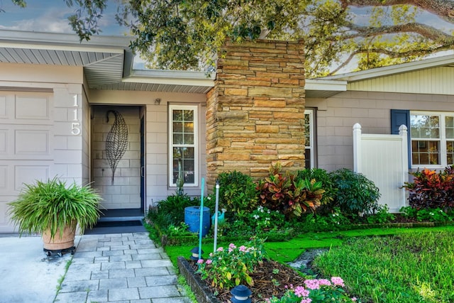 view of exterior entry featuring a garage