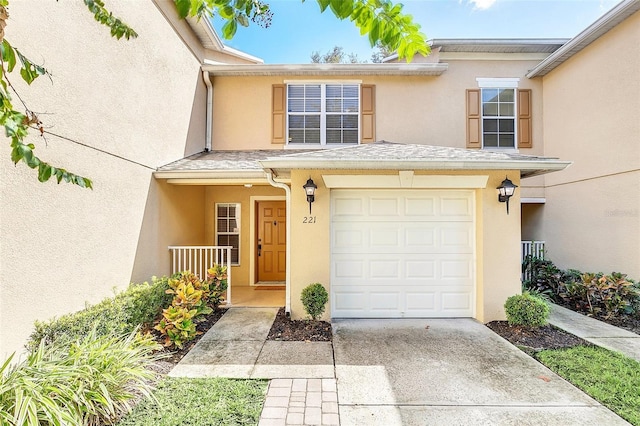 view of exterior entry with a garage