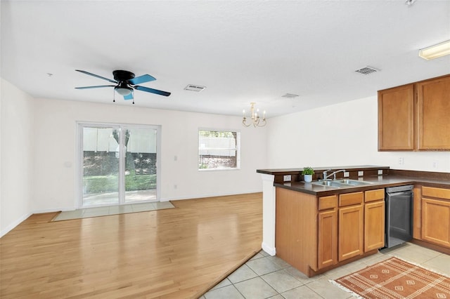 kitchen featuring sink, light wood-type flooring, ceiling fan with notable chandelier, dishwasher, and kitchen peninsula