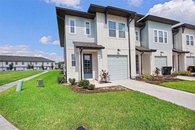 view of property featuring a garage and a front yard