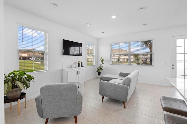 living room featuring light tile patterned floors and a healthy amount of sunlight