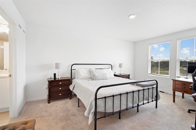 carpeted bedroom featuring connected bathroom