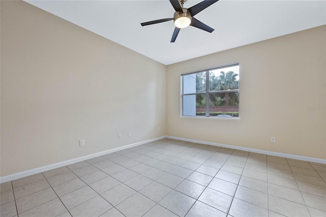 empty room with ceiling fan and light tile patterned flooring