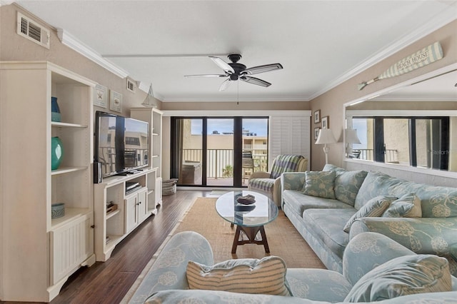 living room featuring ceiling fan, dark hardwood / wood-style floors, and crown molding