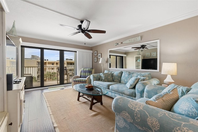 living room with ceiling fan, hardwood / wood-style flooring, and crown molding