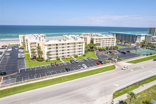 drone / aerial view featuring a view of the beach and a water view