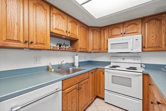 kitchen with white appliances, light tile patterned flooring, and sink