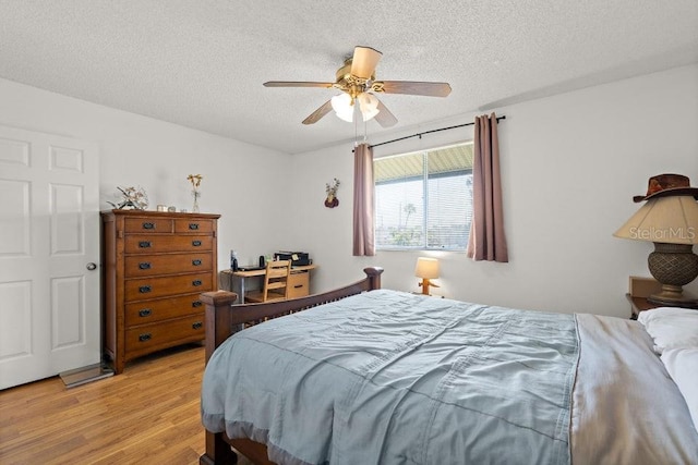 bedroom featuring ceiling fan, a textured ceiling, and light hardwood / wood-style flooring