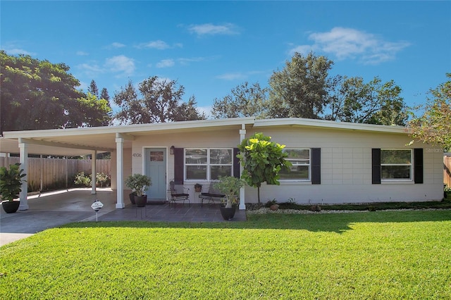 view of front facade with a front yard and a carport