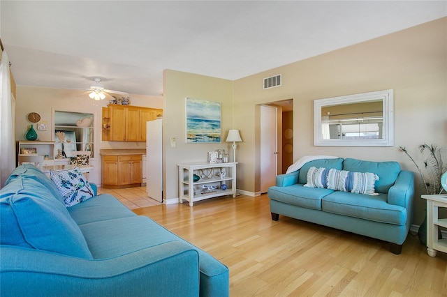 living room featuring ceiling fan and light hardwood / wood-style flooring